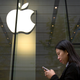 A woman walks past an Apple store in Beijing in 2017.